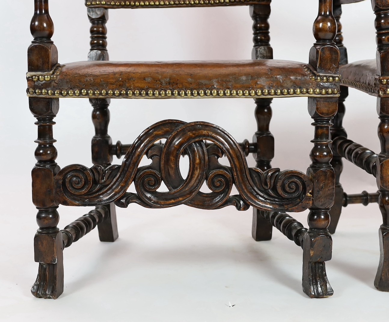 A pair of late 17th century Spanish walnut and elm armchairs